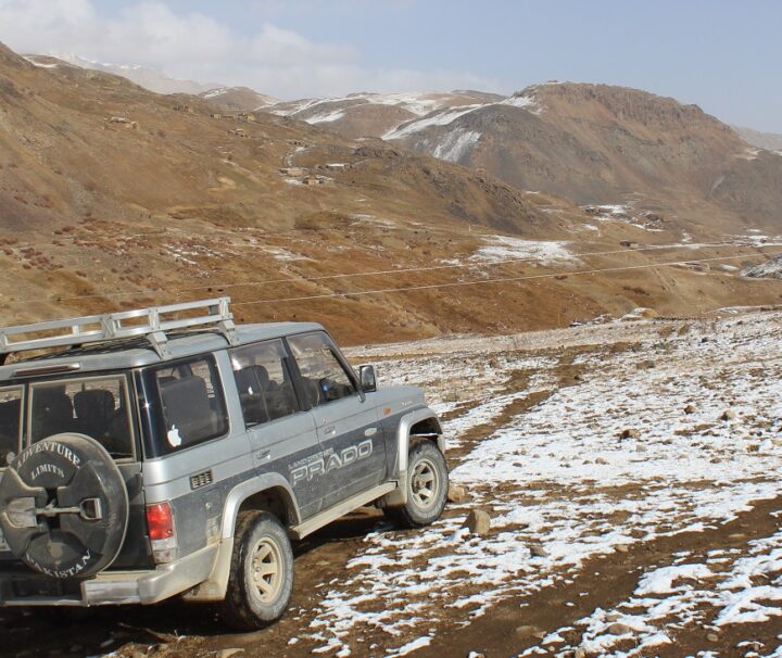 4x4 jeep navigating rugged mountain trails in the Hunza-Shimshal region, Pakistan, during an adventurous safari