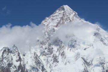 Majestic view of K2, the second-highest mountain in the world, covered in snow with a clear blue sky.